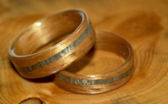 Golden toned koa wood rings with spiraled greyed maple bands