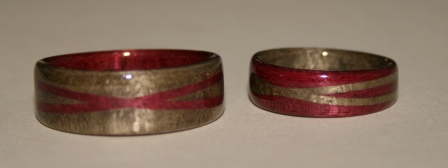 Wooden rings, greyed maple and purple heart wood with crossed spiraled bands