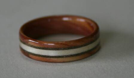 Juniper heartwood ring with three inlaid bands