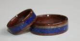 Black Walnut wood rings with Lapis Lazuli inlaid bands and a Grayed Maple inlay on his ring.
