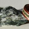 5.5 mm wide Koa wood ring with a center inlay of JADE bordered by clear juniper wood.