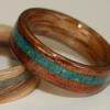 Mid toned Koa wood ring with offset inlay of Israeli EILAT stone.  