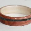 Juniper heartwood ring with a Willow liner and a spiraled inlay of crushed SERPENTINE
