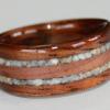 Another Hawaiian Koa wood ring with a center inlay of juniper heartwood bordered by clients crushed STONE inlays.