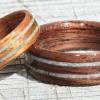 Walnut and Golden Koa rings with two seperated inlays of crushed STONE.