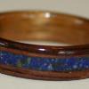 A Rosewood ring with a LAPIS LAZULI inlay and a gold toned Hawaiian Koa liner.