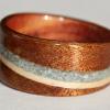 Kauri wood ring with a Juniper heartwood liner and two spiraled inlays.  The wider inlay is ANDEAN OPAL while the narrower inlay is Clear Maple.