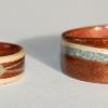 The ring on the left is ANDEAN OPAL inlaid in crossed spiraled bands with a full moon inlay of opal at the junction of cross.  