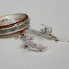 This Black Walnut ring incorporates their own white birch wood a well as a special Tibetan stone, Sage and Sweetgrass for the center inlay.