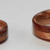 Rosewood rings with golden koa and a Death Valley Sand inlay.  Bethlehem Olive wood interiors.