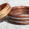 Zoe's Golden Koa ring is 5mm wide with two separate inlays of Larimar Stone  ~ Jose's walnut ring is 7mm wide with a gentle taper to 6mm 