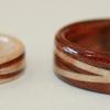 Smaller ring is 4 mm wide birds eye maple wood ring with .5mm wide crossed spiraled inlays of Hawaiian Koa wood.  Koa ring with crossed spiraled inlays of maple is 6mm wide.
