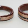 Her ring (with the 'full moon' stone inlay) is 4mm wide tapered to 3mm.  His ring is 6mm, no taper.  Their rings are black walnut and birds eye maple wood with inlays of their own stones.