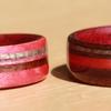 Touch Wood Rings of Pink Ivory Wood, Black Walnut and Greyed Maple.  Her ring also has a very narrow inlay of quartz crystal.