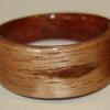 Australian Alpine ASH.  (the interior liner is Australian Red Gum)  This wood ring features a one of a kind natural knot in the ASH.  