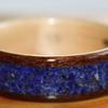 BIRCH.  The interior liner here is Birch wood, the ring is Black Walnut with a wide Lapis Lazuli inlay.  