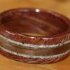 Sacred Hawaiian Kamani Wood with a Hawaiian Kou Wood center inlay bordered by sand from a beach in Hawaii.