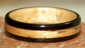 black wood ring lined with birds eye maple